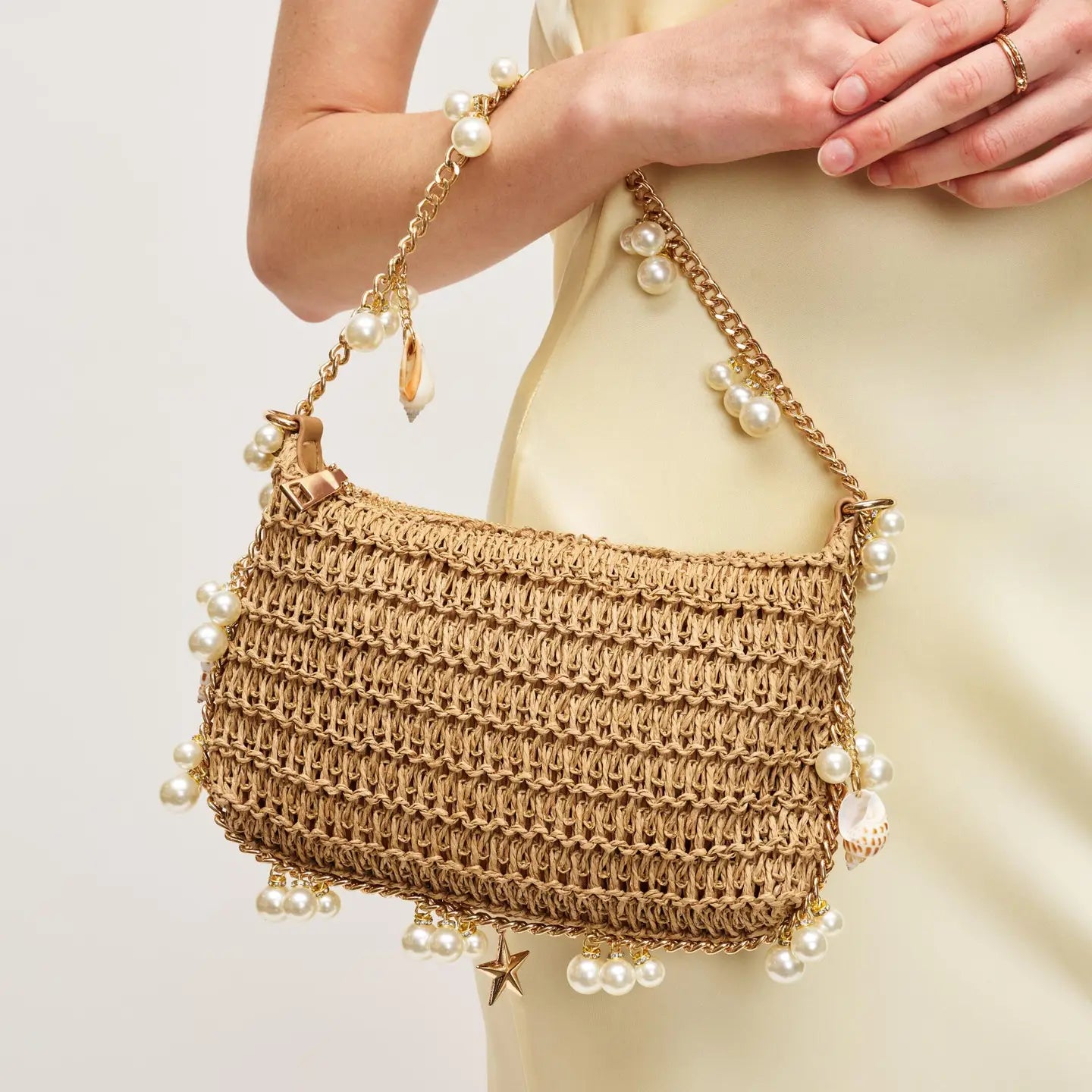 woven bag with seashell and pearl details. perfect for summer beach vacation