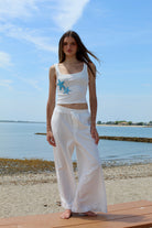 white linen pants with floral lace cut out 