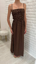 Person wearing a brown polka dot maxi dress. nice summer dress 