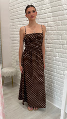 Person wearing a brown polka dot maxi dress. nice summer dress 