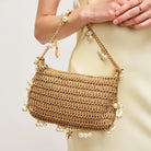 woven bag with seashell and pearl details. perfect for summer beach vacation