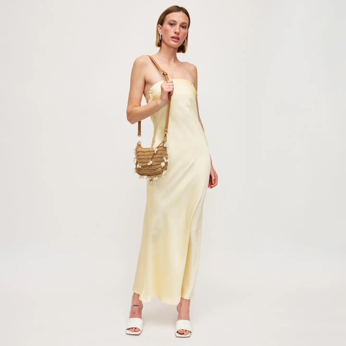 woven bag with seashell and pearl details. perfect for summer beach vacation